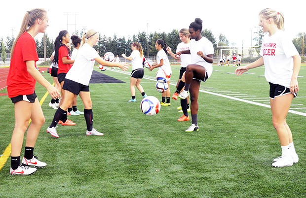 The Marysville-Pilchuck girls soccer team practices its kicks during a drill.