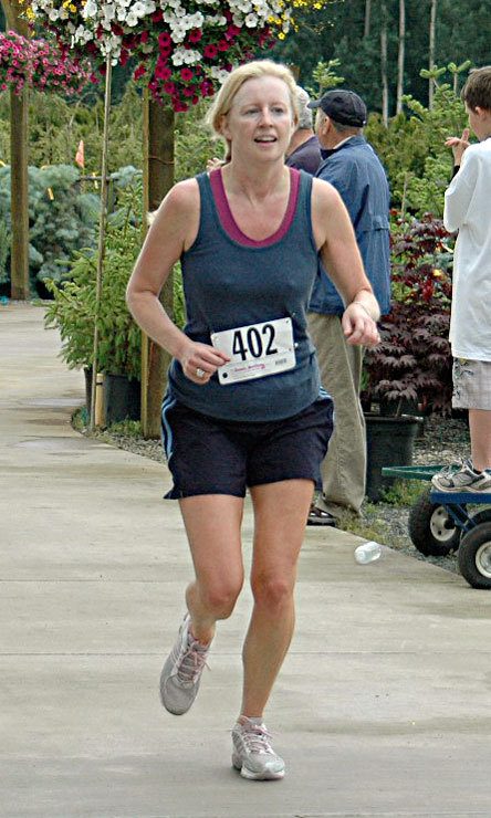 Susan Northrop runs to the finish line of the Berry Run