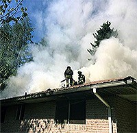 Firefighters battle a smokey blaze in Arlington Monday.