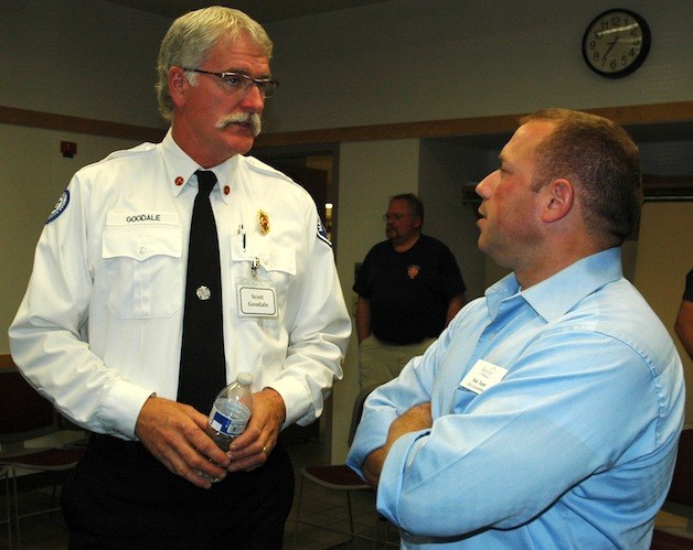 Marysville Fire Battalion Chief K. Scott Goodale speaks with City Council member Rob Toyer at the fire chief candidates' July 23 meet-and-greet with the public at Marysville Fire District Station 62.