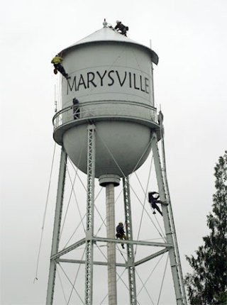 Marysville firefighters work Nov. 29 to prepare the water tower lights for the Merrysville Electric Lights Parade Dec. 6.