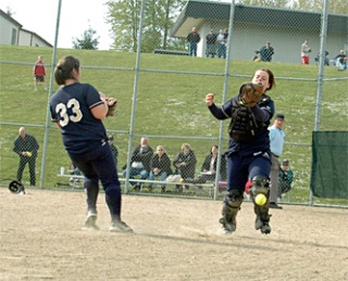 Arlington catcher Torrey Herrington caught a couple of pop-up fouls for outs but couldn’t quite get her glove under this one in the fourth inning to close it out. Lisa Allen comes in from third base to offer support.