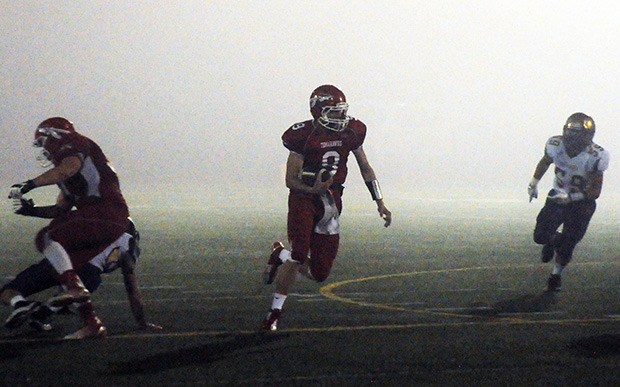 Erik Lind keeps the ball for a run.