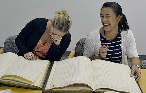 Marysville communications officer Bronlea Mishler and records officer Tina Brocks laugh at the wording in some of the city's first laws