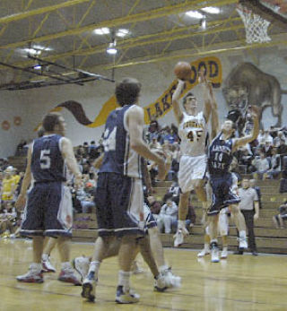 Lakewood junior Nathan Hesselman is focused on the basket as he takes a shot early in the Cougars’ win over Lambrick Park. “He’s shooting well and knows how to use his body
