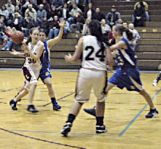 Senior Jocelyn Shafer passes to teammate Maria Wiederkehr.