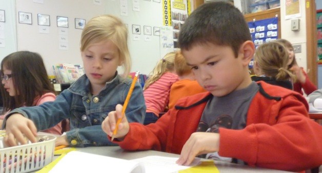 Kalaikona Vea and Sydney Scott work on an writing exercise about emotions in Veronica Underwood’s kindergarten class.