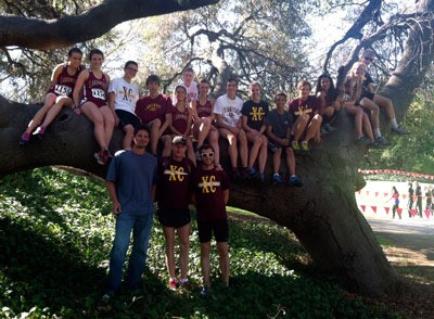Fourteen Lakewood runners pose with coaches and alumni at the 40th Stanford Invitational.