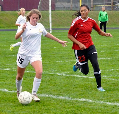 Lakewood’s Maddie DeYoung holds off the Wolves during a home game against Coupeville on Tuesday