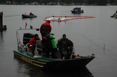 Snohomish County Technical Water Rescue Team members bring a float plane into the Wenberg County Park boat dock on Jan. 24