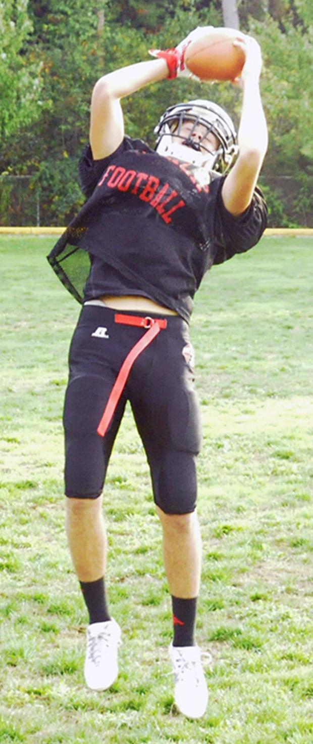 Robert Miles Jr. of Heritage High School jumps up to catch a ball during practice.