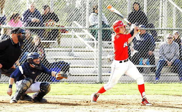 Marysville-Pilchuck's Alex Aumick connects with an Arlington pitch.