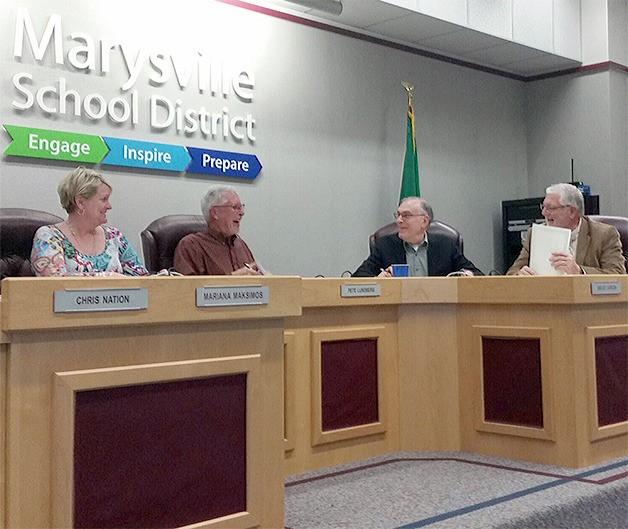 Superintendent Becky Berg smiles along with school board members Pete Lundberg