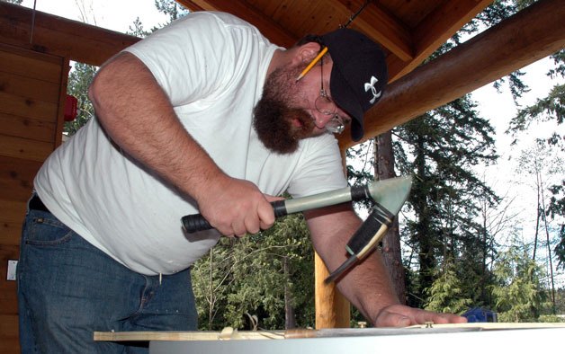Tulalip Tribal member Jason Gobin tapers down the blade of a canoe paddle at the Hibulb Cultural Center on April 21.