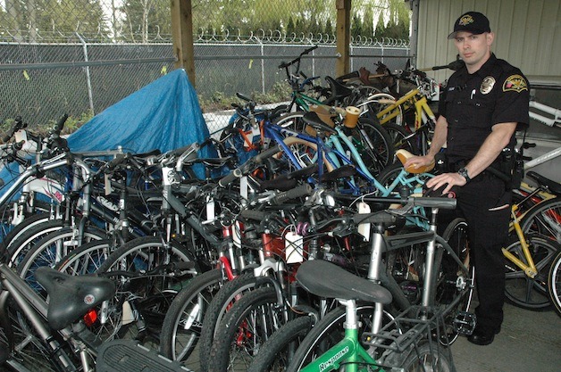 Marysville Police Officer Bill Belleme surveys the more than 60 bicycles that were recovered through a stolen property warrant on April 3.