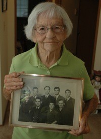 Verna Gibson holds a photo of her parents and her five brothers