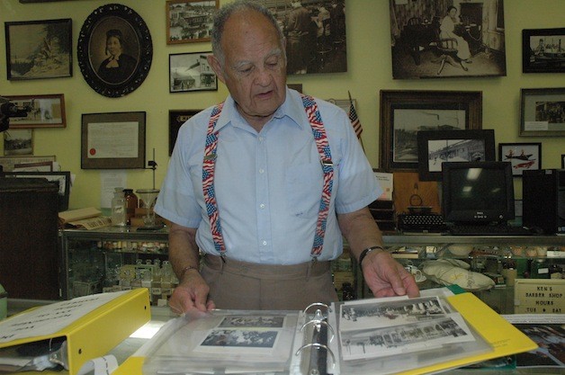 Marysville Historical Society President Ken Cage peruses some of the books of old photos that will be on display for the public during the Marysville Street Festival: Handmade & Homegrown from Aug. 9-11.