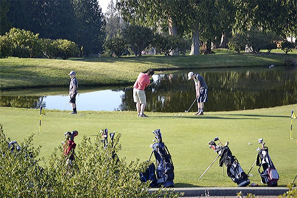 Arlington's boys high school golf team practices on the putting green at scenic Gleneagle Golf Course.