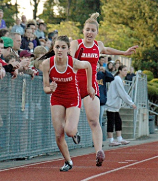 M-P senior Laina Weber hands off to teammate Kayla Thistle in the girls 4x200 relay