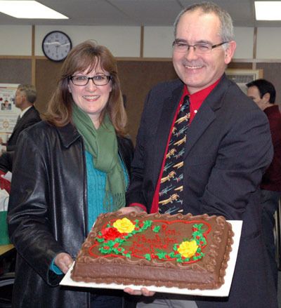 Kathy and Ken Christiansen show off his going-away cake at his last Lakewood School District Board of Directors meeting as Director District 3 on Dec. 18.