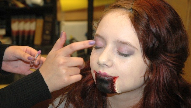 Cassie Gibson receives a test face-painting to prepare for the Arts & Technology High School's haunted house Oct. 24-25.
