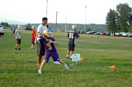 Quarterback Max Maciejewski got to work on his passing skills at one station of the Marysville youth football camp during the last week in July.