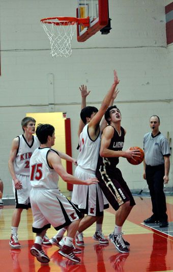 Dillon Knott grabs an offensive rebound and tries to put it back in for the Cougars.