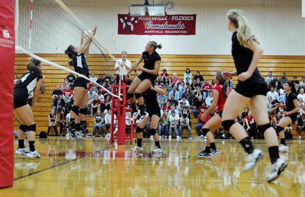 Senior middle blocker Alisha Oden stuffs the ball into the hands of some Snohomish blockers