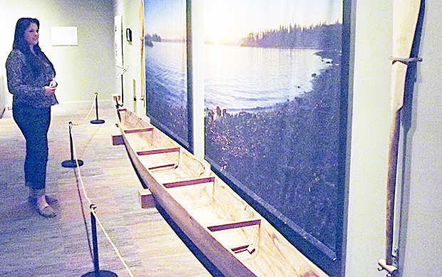 Emily Delante looks over the Salish canoe display at the Hibulb Cultural Center in Tulalip Aug. 13. The center is celebrating its third anniversary Saturday