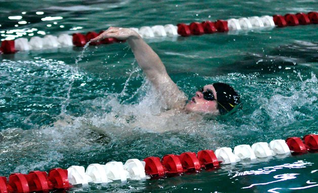 MG’s Michael Cozart completes the backstroke portion of the 200-yard individual medley in a meet against Everett High School on Thursday
