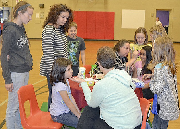 Kids gather around the face-painting table at the Marysville Boys and Girls Club Open  House last week.