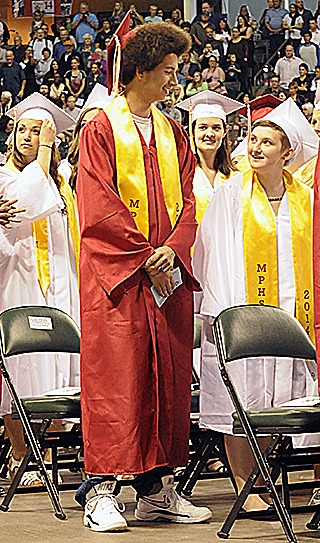 Chris Franklin talks to other graduates at the Marysville-Pilchuck ceremony at Comcast Arena in Everett. Franklin was the victim of a shooting about three weeks ago