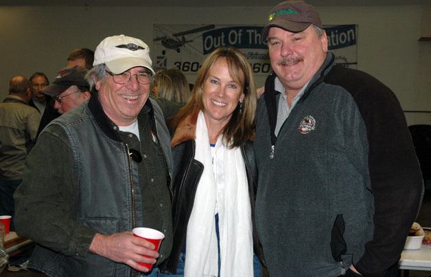 Outgoing Out of the Blue Aviation owner Cathy Mighell is flanked by friends Dan Tarasievich at left