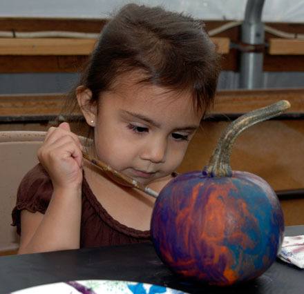 Burlington’s Alyssa Cabral concentrates intently on painting her pumpkin at the Sunnyside Nursery ‘Customer Appreciation Day’ on Oct. 1.