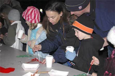 A family creates Christmas decorations on Dec. 5 during the 21st annual Merrysville for the Holidays event.