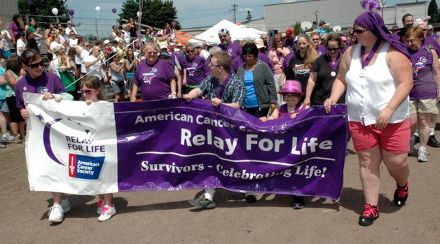 Cancer survivors kick off the 2013 Marysville Tulalip/Relay For Life with the opening lap at Asbery Field on June 29.