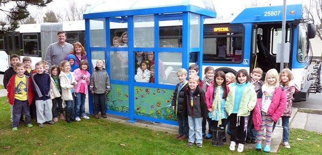 First-grade students of the Marysville Cooperative Education Program at Marshall Elementary stand beside the community art they applied to the Community Transit bus shelter on 64th Street NE