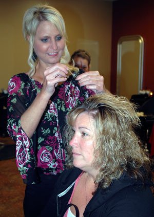 Beth Hauck adds FeatherLocks to Stephanie Barker’s hair at Salon de Porres in Tulalip.