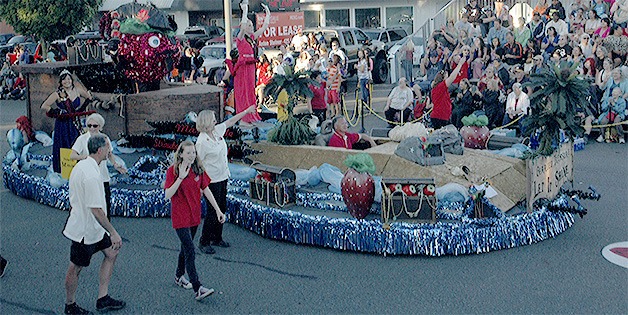The Marysville Strawberry Festival float glides down State Avenue during the Grand Parade June 20. Maryfest volunteers accompany the royalty on the float.