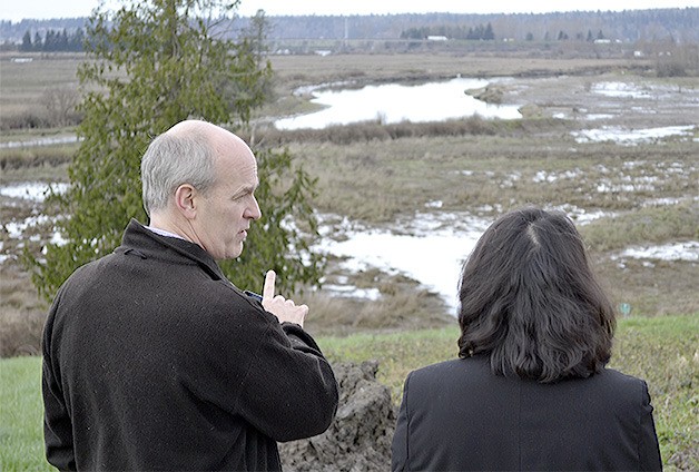 U.S. Rep. Rick Larsen talks with Marysville Chief Administrative Officer Gloria Hirashima while overlooking the Qwuoolt Estuary. Larsen gave city officials some ideas on where some possible federal money could come from to help build trails along the water.