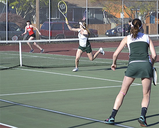 Gabby Grandbois poaches at the net to hit a backhand winner in the No. 1 doubles match Tuesday.