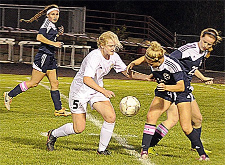 Lakewood's Stephanie Smith battles for possession from Sultan defender.