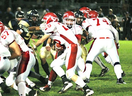 M-P quarterback Tylor Klep hands the ball off to halfback Cody House.
