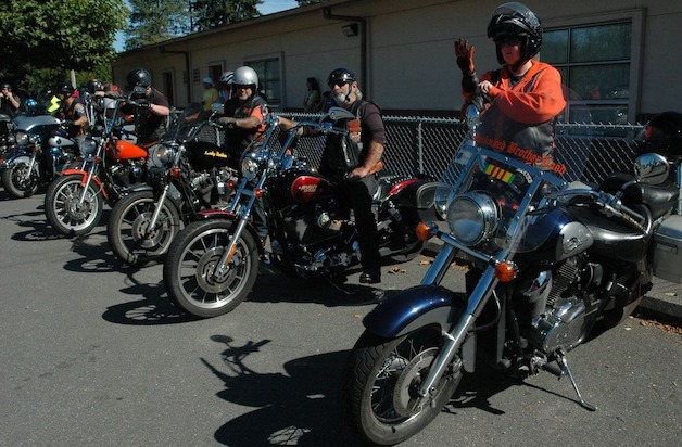 Members of the Unchained Brotherhood motorcycle group head out of the Shoultes Elementary parking lot for 120-mile ride to raise funds for the school Sept. 13.