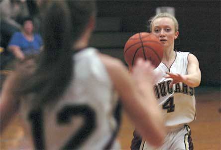 Lakewood junior Natalie Raymond leads a fast break by passing the ball to open teammate Jordan Wessell for a jump shot.