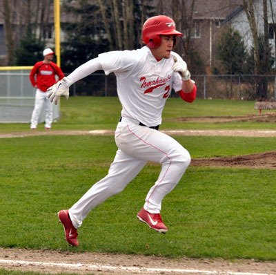Marysville-Pilchuck’s Taylor Wade runs to first during the March 27 home game against Oak Harbor.