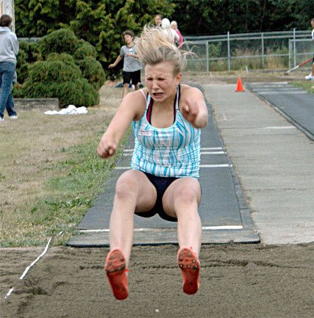 Arlington resident Melissa Webb launches herself into the long jump pit. She set records on the final night of the Marysville all-comers track meet in the 100- and 200-meter dash.