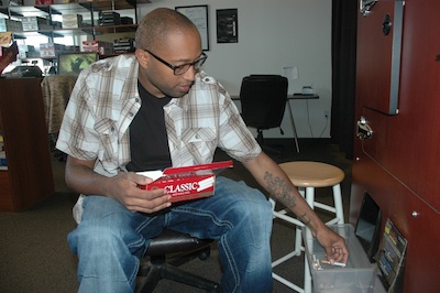 Marysville's Elijah Thornton uses the machine at the Tobacco Joe's roll-your-own cigarette store in Marysville to make his own cartons of smokes.