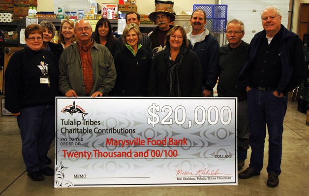 Members of the Tulalip Tribes and the Marysville Community Food Bank met up at the Food Bank’s building on Nov. 15 for the Tulalip Tribal members to hand over a check for $20