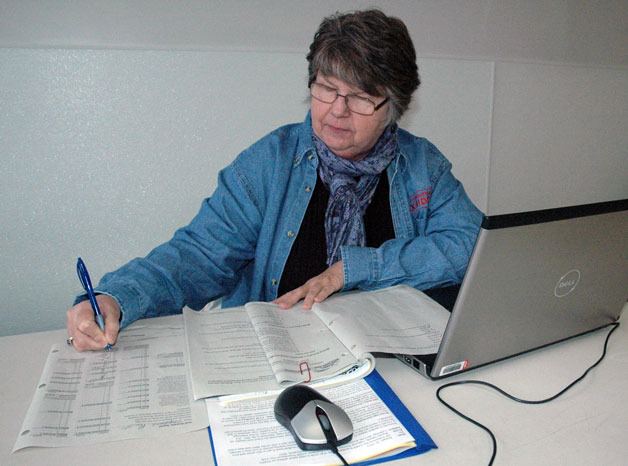AARP volunteer tax preparer Stephanie Pruitt double-checks her math while processing a return at American Legion Post 178 on Feb. 6.